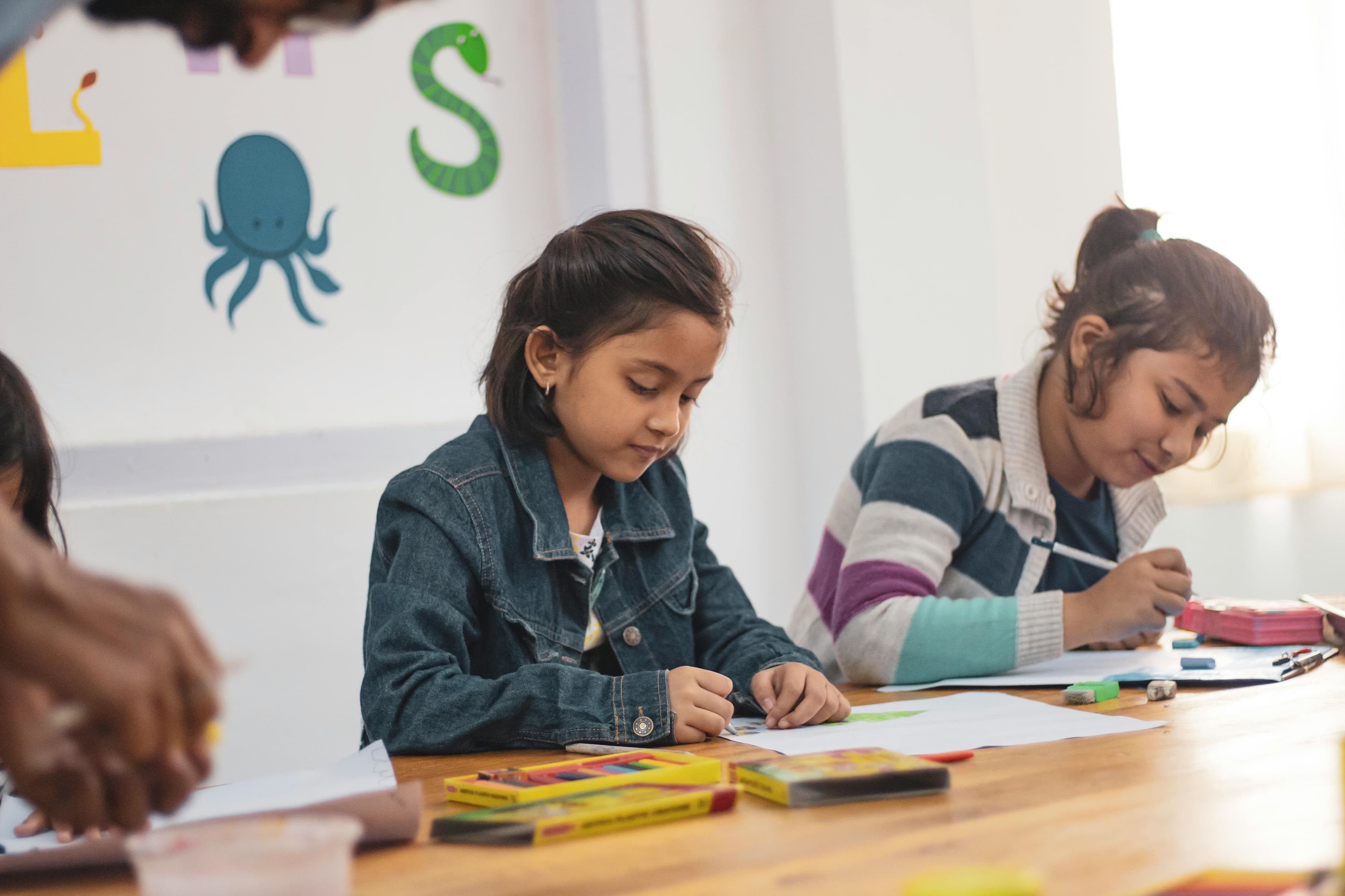 Children studying together at a shared table